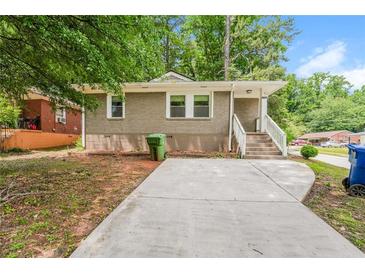 Charming single-story home with a brick facade, concrete driveway, and landscaped front yard at 1381 Benteen Way Southeast, Atlanta, GA 30315