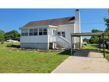 Charming home with a well-maintained yard and convenient carport at 7217 Union Grove Rd, Lithonia, GA 30058