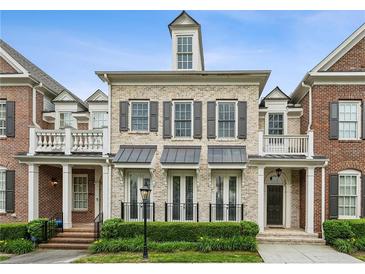 Charming brick townhome featuring black shutters and a manicured front yard at 3585 Roxboro Ne Rd # 2, Atlanta, GA 30326