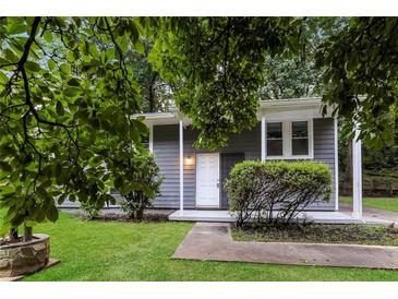 Charming single-story home with gray siding, white trim, and a well-manicured lawn at 6480 Port A Prince Drive Dr, Forest Park, GA 30297