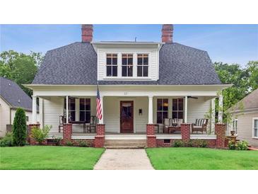 Charming two-story home with white siding, inviting front porch, and well-maintained lawn at 27 Sessions Nw St, Marietta, GA 30060