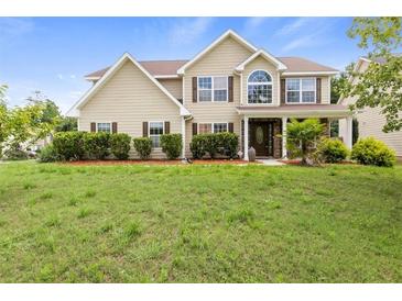 Charming two-story home with landscaped yard and inviting front porch at 3385 Amhurst Pkwy, Atlanta, GA 30349