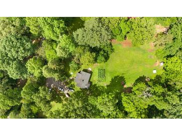 An aerial view showcases the property with a home, surrounded by lush greenery and a well-maintained yard at 12728 Bells Ferry Rd, Canton, GA 30114