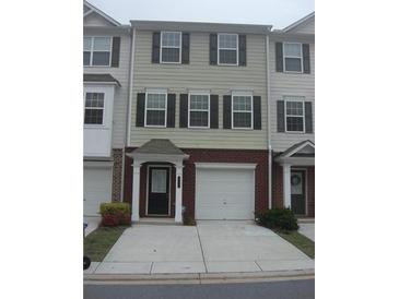 Two-story townhome with brick accents, a front-entry garage and black shutters for a clean, modern look at 6895 Slate Stone Se Way # 3, Mableton, GA 30126