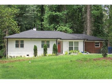 Charming one-story home with a brick facade, neat landscaping, and a well-maintained green lawn at 3175 West Manor Sw Cir, Atlanta, GA 30311
