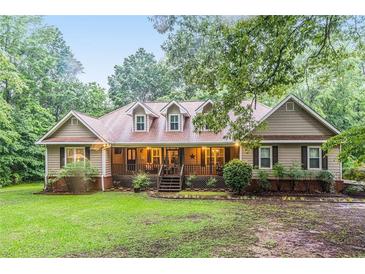 Charming ranch-style home features a welcoming front porch and well-maintained landscaping at 324 Kibbee Rd, Mcdonough, GA 30252