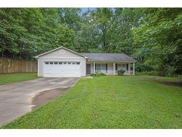 Charming single-story home featuring a manicured lawn and an attached two-car garage at 10073 Dorothy Ct, Jonesboro, GA 30236