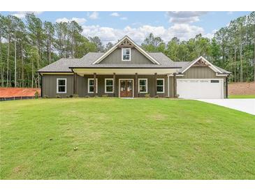 Inviting single-Gathering home with a well-manicured lawn and a charming covered front porch at 96 Lexie Ct, Rockmart, GA 30153