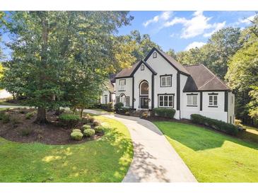 Elegant two-story home with a well-manicured lawn and circular driveway at 4670 Hamden Forest Sw Dr, Atlanta, GA 30331