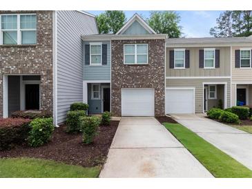 Charming townhome with brick facade, garage, well-maintained landscaping, and inviting curb appeal at 3155 Tarian Way, Decatur, GA 30034