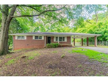 Charming brick ranch-style home featuring a covered carport and well-maintained landscaping at 4567 Parkway Cir, Atlanta, GA 30349