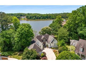 Stunning waterfront home with lush landscaping, private drive and lake view at 507 Cross Creek Pt, Stone Mountain, GA 30087