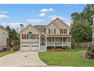 Charming two-story home with a welcoming front porch, attached two-car garage, and landscaped yard at 113 Westchester Xing, Canton, GA 30115