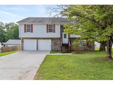 Charming two-story home with a two-car garage and stone accents and front lawn at 946 Redan Trce, Stone Mountain, GA 30088