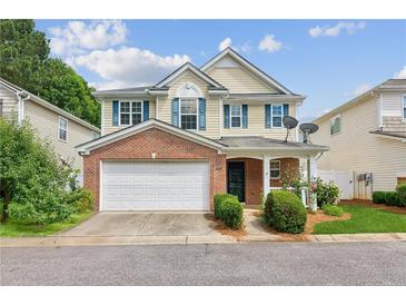 Charming two-story home with a brick facade, attached garage, inviting front porch, and manicured landscaping at 3698 Roseman Lndg, Cumming, GA 30040