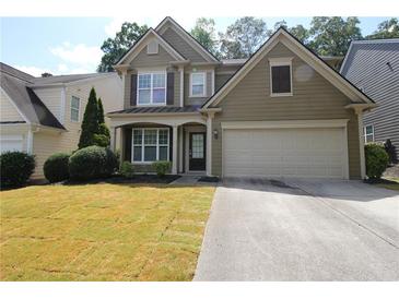 Charming two-story home with a well-maintained lawn and two car garage at 942 Idlewood Dr, Canton, GA 30115