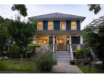 Charming two-story home featuring a welcoming front porch and beautifully landscaped front yard at 1602 Windsor Walk, Avondale Estates, GA 30002