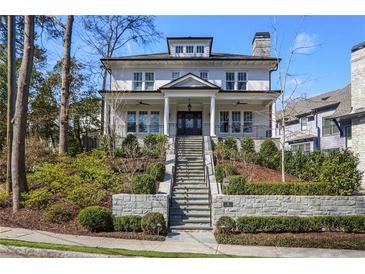 Stunning two-story white brick home with manicured landscaping and inviting staircase at 18 Polo Ne Dr, Atlanta, GA 30309