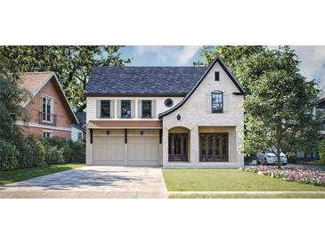 Charming two-story home featuring a blend of stone and siding, complemented by an attached two-car garage and landscaped front yard at 1115 Ralph Ne Rd, Atlanta, GA 30324
