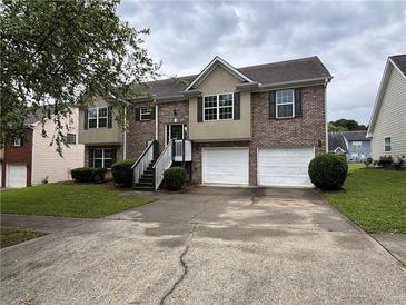 Charming two-story home featuring a brick facade, attached two-car garage, and inviting front steps at 4069 Savannah Ridge Ct, Loganville, GA 30052