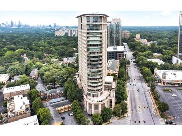 Stunning aerial view of a modern high-rise building in a bustling city, surrounded by lush greenery at 2881 Peachtree Ne Rd # 1202, Atlanta, GA 30305