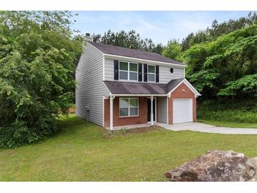 Charming two-story home with brick and vinyl siding and attached one car garage at 3915 Cypress Pointe Dr, Union City, GA 30291