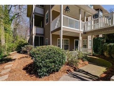 Multi-level home showcasing a deck and well-maintained landscaping at 2135 N Forest Trl, Dunwoody, GA 30338