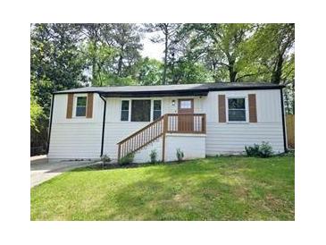 Charming single-Gathering home with white siding, inviting front porch, and well-manicured lawn at 2190 Gordon Se Cir, Smyrna, GA 30080
