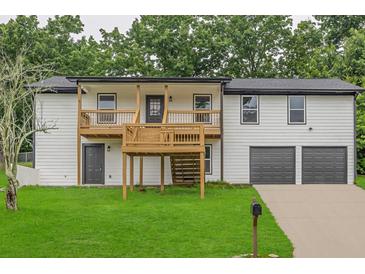 Charming two-story home featuring a spacious front yard, upper balcony, and a two car garage at 3233 Glynn Mill Dr, Snellville, GA 30039