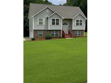 Charming two-story home with a well-manicured front yard and a welcoming entrance at 45 Avery Drive, Covington, GA 30016