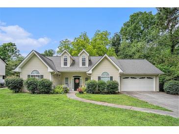 Charming single-Gathering home with well-manicured lawn, mature trees, and attached two car garage at 1907 S Van Wert Rd, Villa Rica, GA 30180