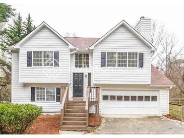 Charming two-story home with an attached garage and inviting front porch steps at 5710 Cardigan Trce, Sugar Hill, GA 30518