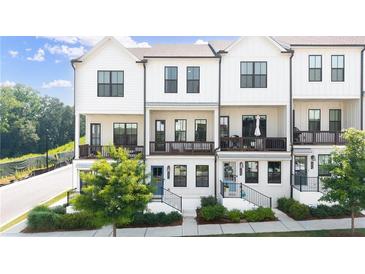 Beautiful townhome exterior with white siding, black trim, private balconies and landscaping at 1247 Zucchini Se Cir, Atlanta, GA 30315