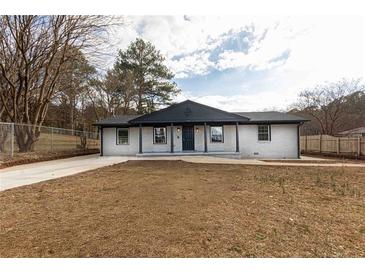 Charming single-story brick home with covered porch and well-maintained front yard, updated with a fresh modern design at 935 Conley Se Rd, Atlanta, GA 30354