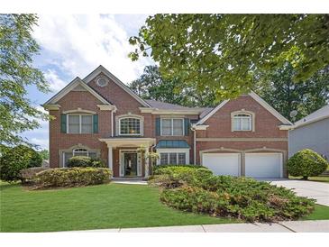 Charming two-story brick home with a well-manicured lawn and lush landscaping at 250 Lawrence Pl, Atlanta, GA 30349