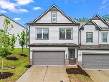 Charming townhome with a well-maintained lawn and a two-car garage at 359 Crider Ct, Woodstock, GA 30188
