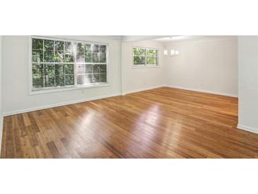 Bright living room featuring hardwood floors, large windows, and plenty of natural light at 311 Peachtree Hills Ne Ave # 13B, Atlanta, GA 30305