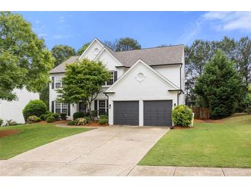 Charming two-story home with a well-manicured lawn and a two-car garage at 5156 Amberden Hall Dr, Suwanee, GA 30024