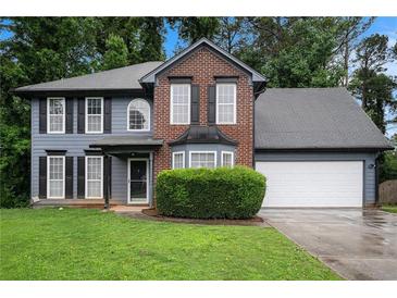 Traditional two-story home with brick and siding, featuring a well-manicured front yard at 6092 Giles Ct, Lithonia, GA 30058