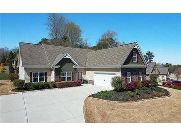 Charming single-story home featuring a lush, landscaped front yard and an attached two-car garage at 15 Azalea Lakes Ct, Dallas, GA 30157