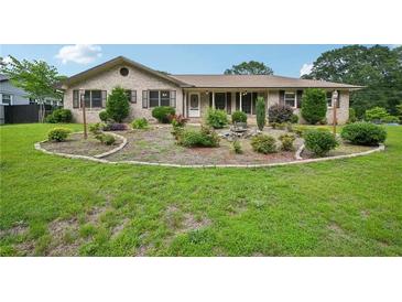 Charming brick home with a well-manicured front yard and inviting curb appeal at 2676 Abington Dr, Snellville, GA 30078