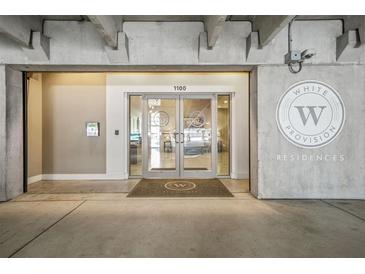 Modern building entrance featuring glass doors and prominent signage for White Provision Residences at 1100 Howell Mill Nw Rd # 212, Atlanta, GA 30318