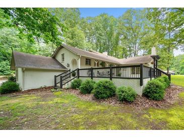 Charming ranch-style home with a black-railed deck, offering serene outdoor living space at 3252 Custer Lake Drive Northwest Nw Dr, Marietta, GA 30064