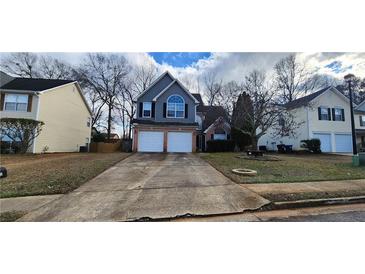 Charming two-story home featuring a two car garage and a well-maintained front yard at 1230 Chris Lake Dr, Lawrenceville, GA 30046