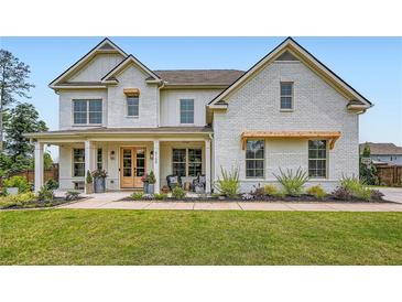 Beautiful two-story home with a charming brick exterior, covered porch and manicured landscaping at 6168 Sweet Birch Ct, Acworth, GA 30101