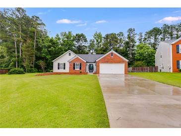 Charming single-story brick home with a well-manicured lawn and attached two-car garage at 4490 Epworth Court Ct, Powder Springs, GA 30127