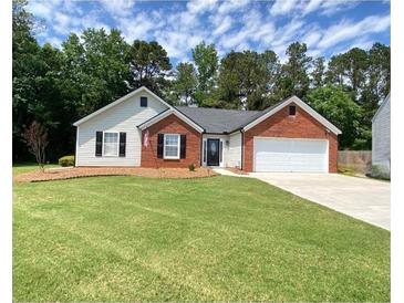 Charming single-story home with a well-manicured lawn, brick accents, and an attached two-car garage at 4490 Epworth Court Ct, Powder Springs, GA 30127