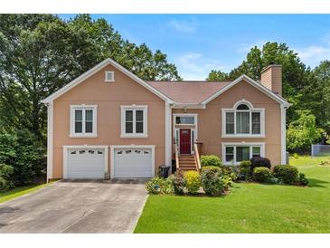 Charming two-story home with a well-manicured lawn and a two-car garage at 920 Highfield Ct, Lawrenceville, GA 30043