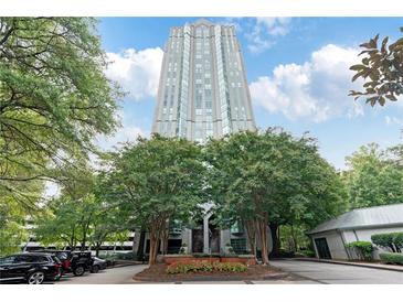Striking high-rise condominium exterior with mature trees and manicured landscaping in a beautiful city setting at 2870 Pharr Court South Nw # 1704, Atlanta, GA 30305