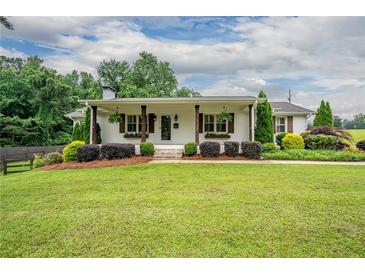 Charming one-story home with manicured lawn, covered porch, and inviting curb appeal at 4067 Mason Creek Rd, Winston, GA 30187